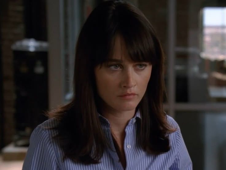 Teresa Lisbon watching Patrick Jane work, unimpressed and unmoving.
